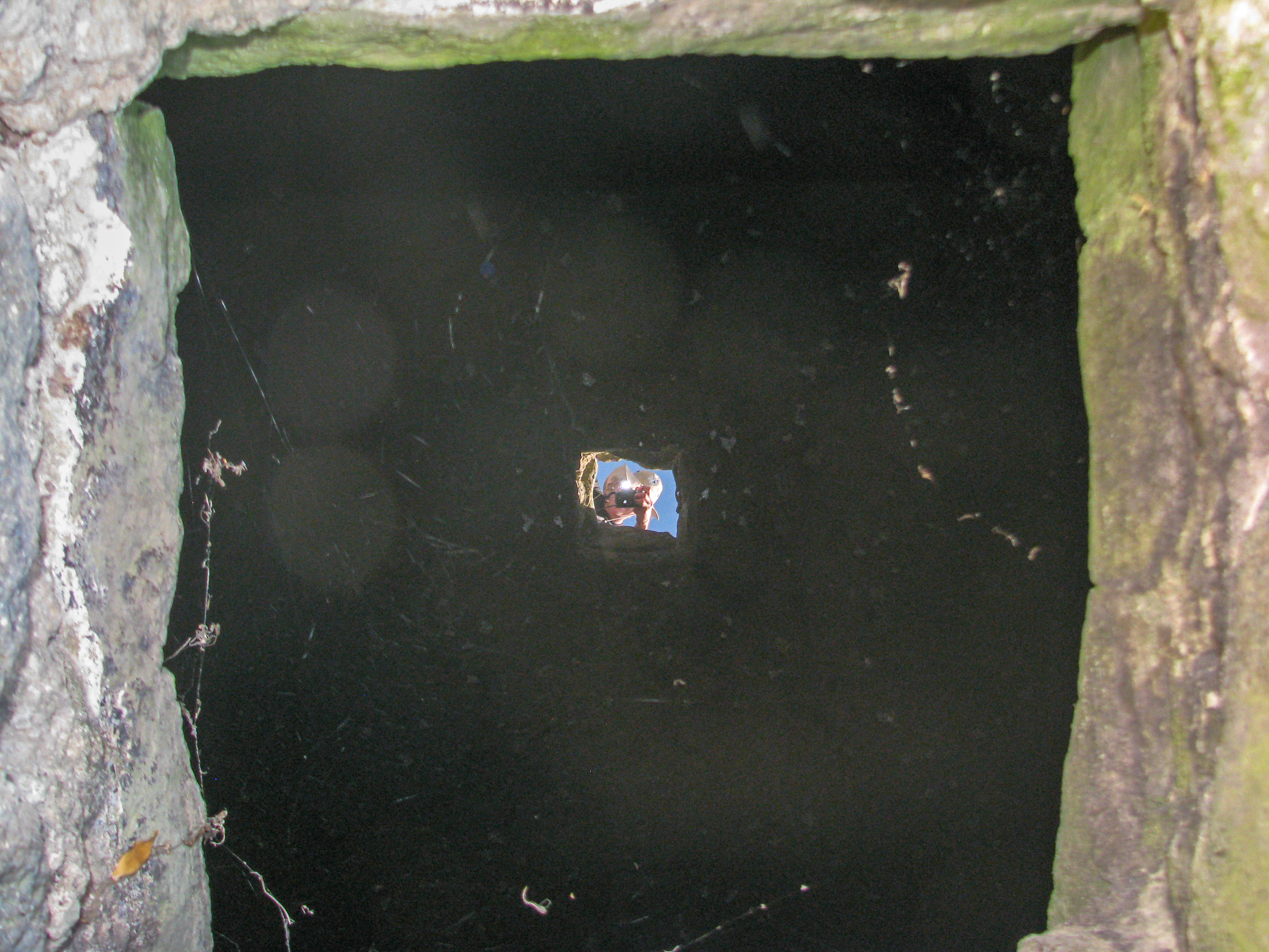 Looking down a well.