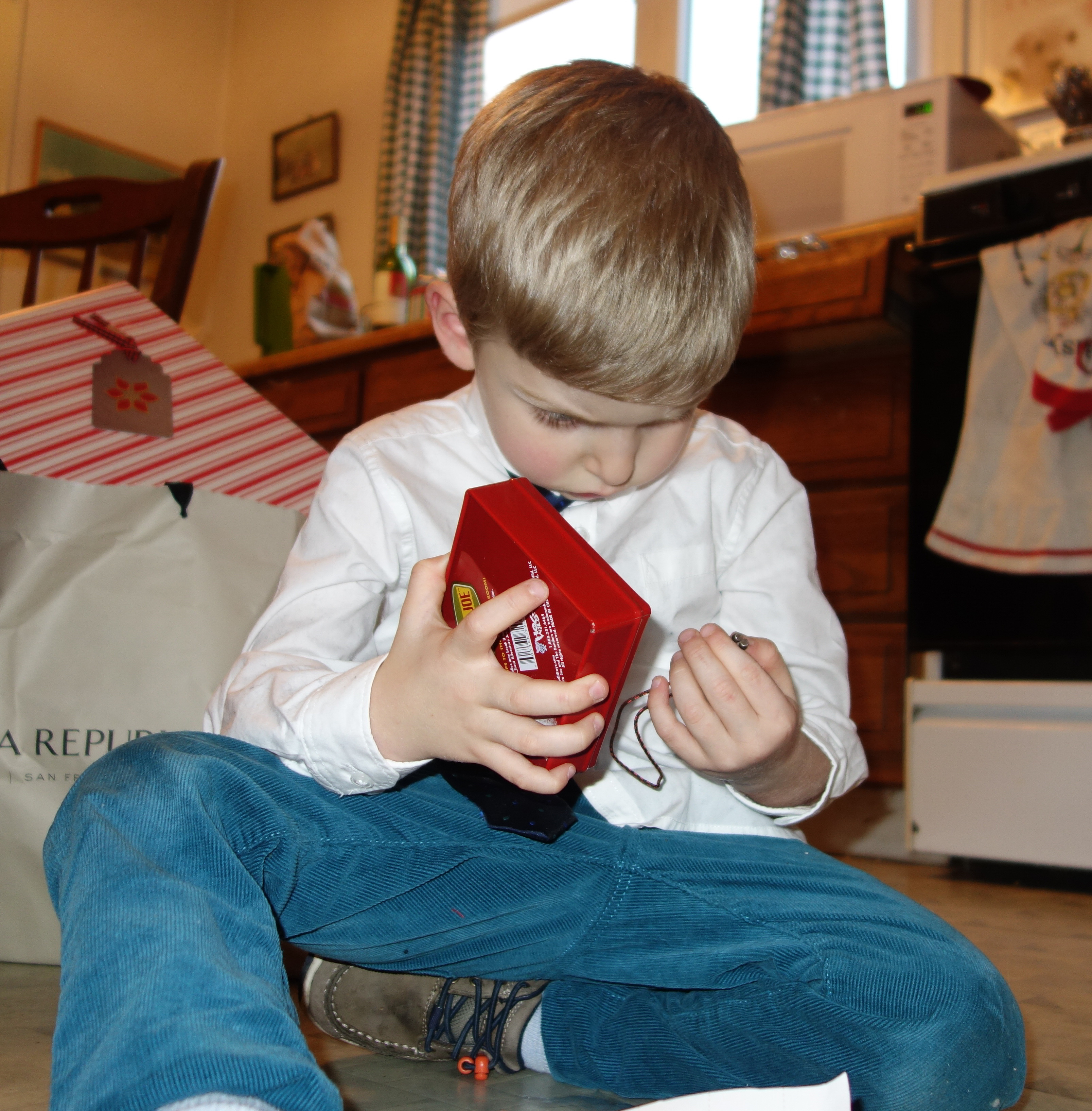 Alexander attends to a present on Christmas Day. He can become engrossed.